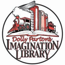 Row of books with train bookends, sitting on an open book. Dolly Parton's Imagination Library