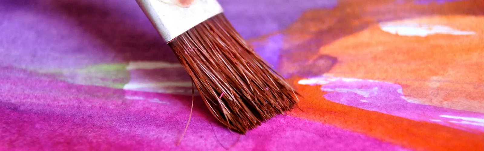 Paintbrush creating watercolor painting